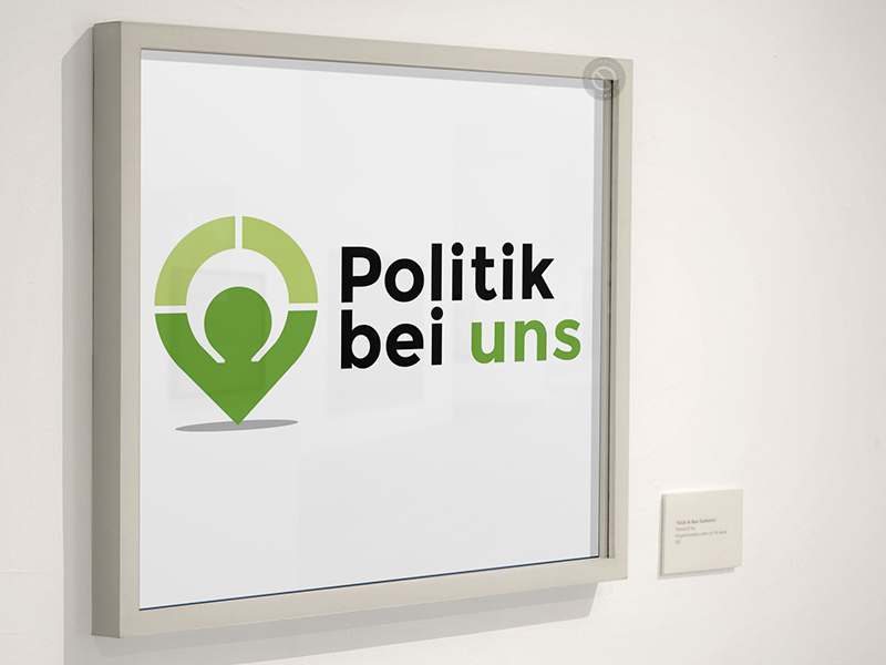 Logo-Entwicklung Politik-Bei-Uns Gestaltung eines Logos – hier in der Anwendung als Türschild